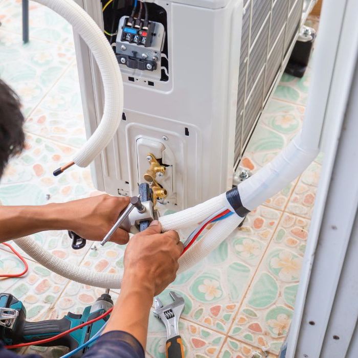 Technician servicing a residential heating and air conditioning system in Brooklyn, New York